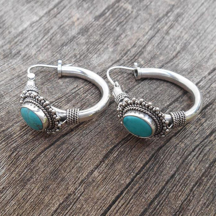 Eleganta örhängen i sterlingsilver med turkosmotiv