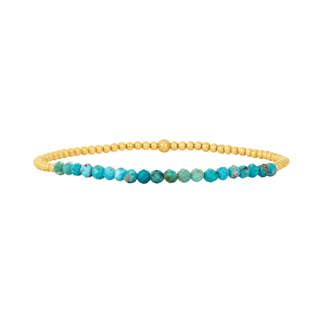 Elegant armband i 18 karat guld med turkosa pärlor
